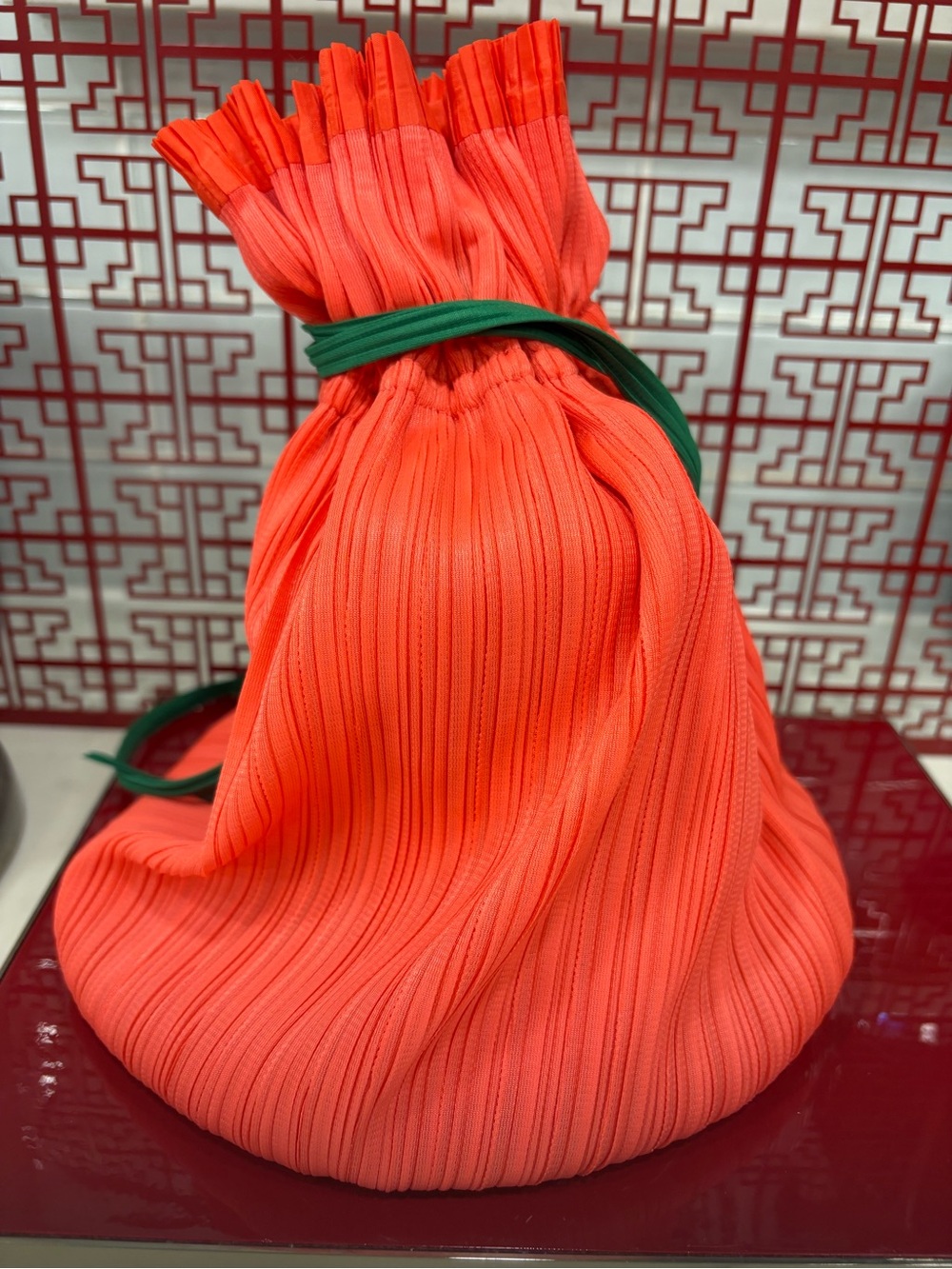 Brand new vibrant coral red Pleated Drawstring Women’s Bag with Green Strap